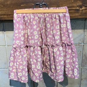 Pink skirt with daisies.